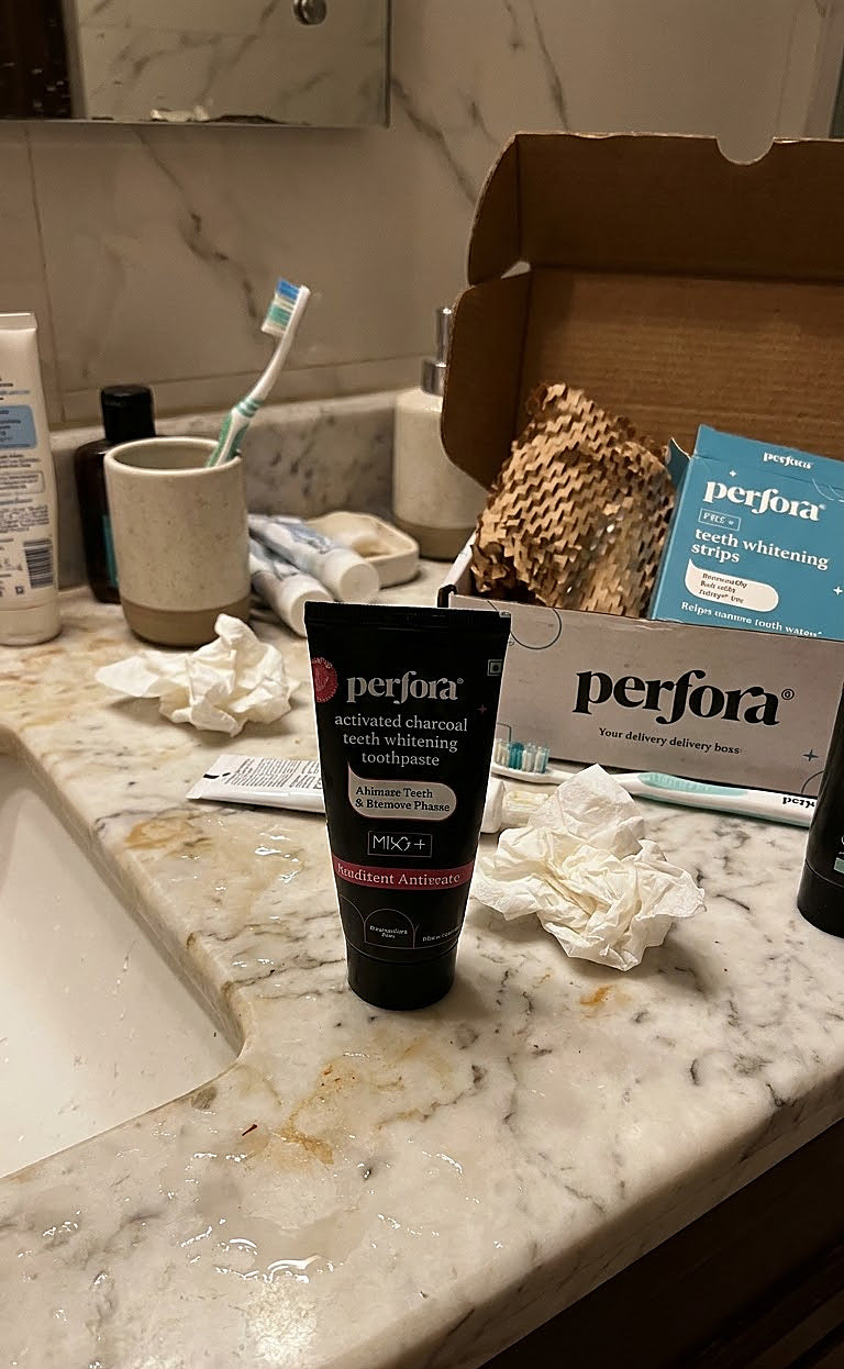 Divya Deshmukh holding Perfora Purple Magic Whitening Toothpaste